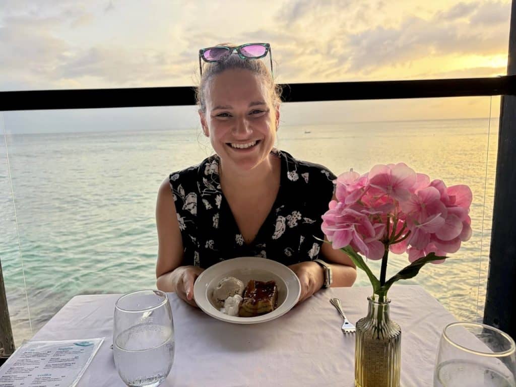 Nicola eating bread pudding for dessert at the view restaurant in holetown barbados