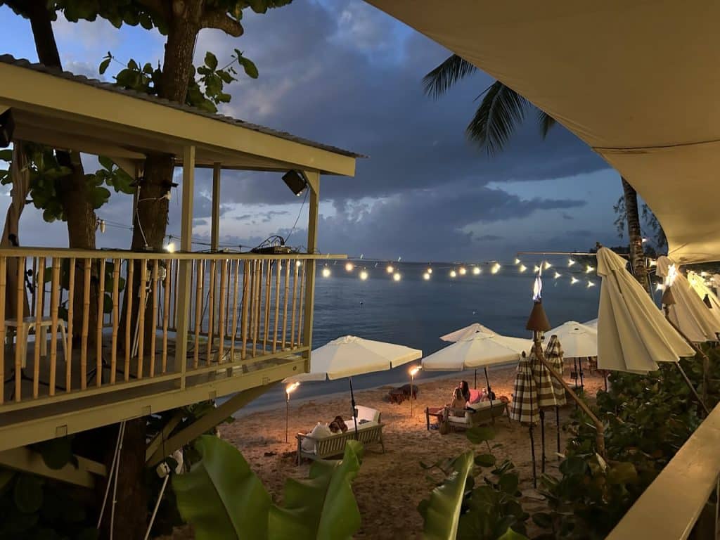 Sea Shed after dark with twinkle lights out over the ocean