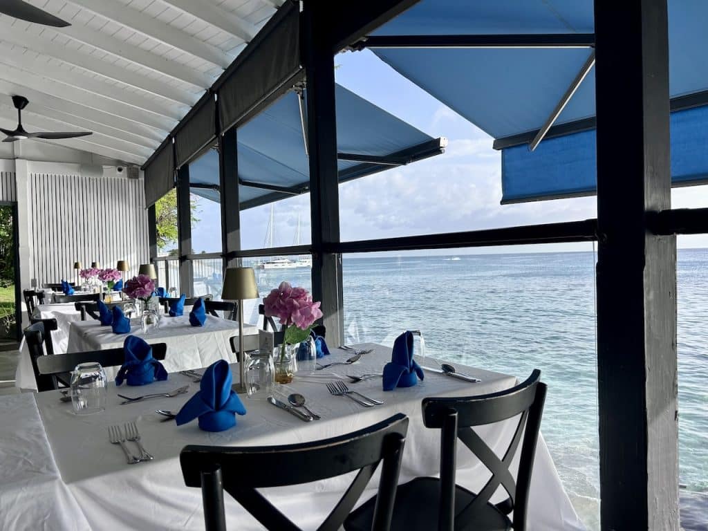 A white table cloth table with a sea view at The View restaurant in Holetown